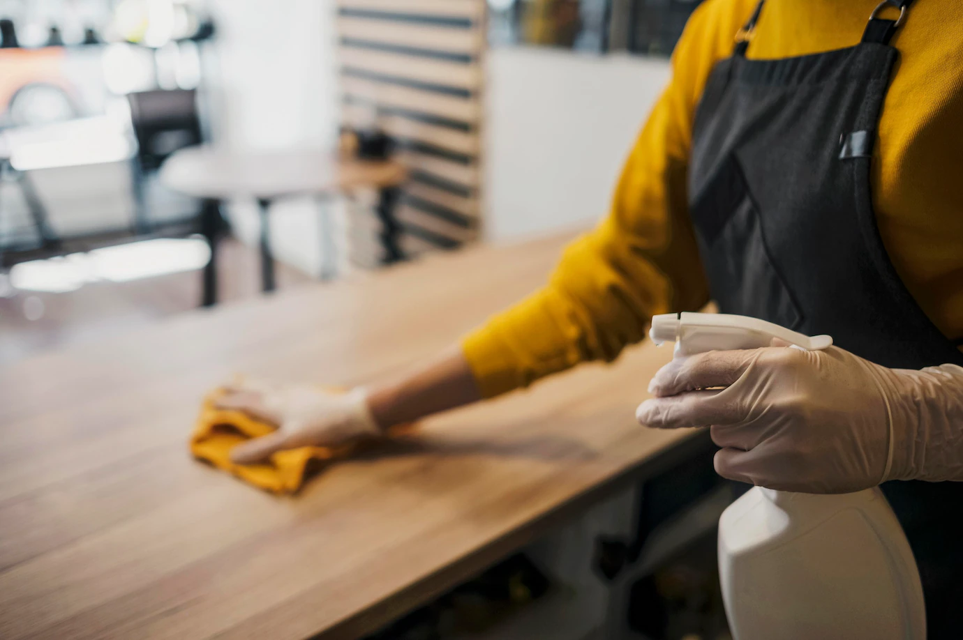 side view female barista cleaning table while wearing latex gloves 23 2148522930